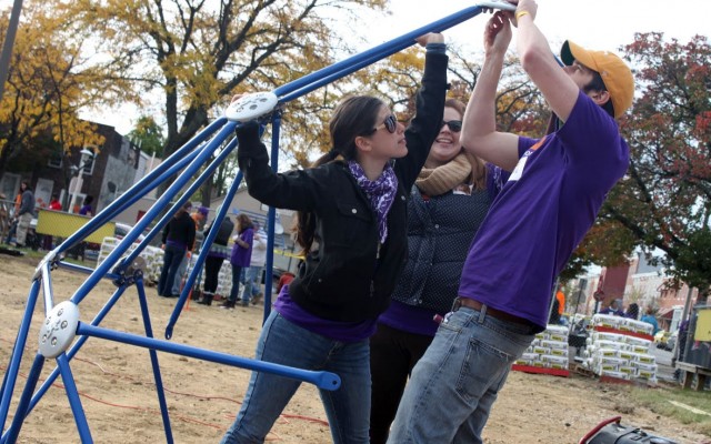 volunteers assemble jungle gym