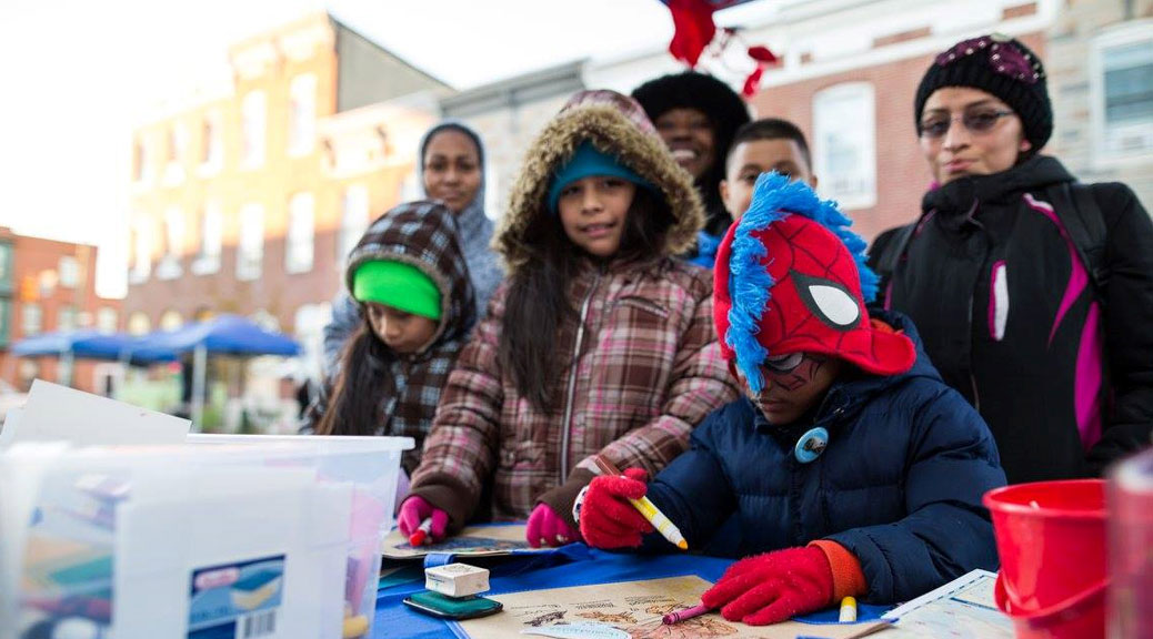 kids drawing at bus shelter dedication